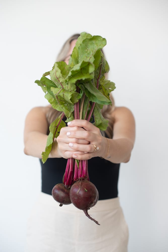 Kate Brock holding beets in hand