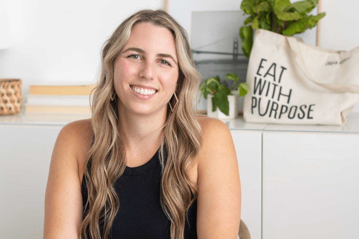 Kate Brock of Kate Brock Nutrition sitting at her desk smiling